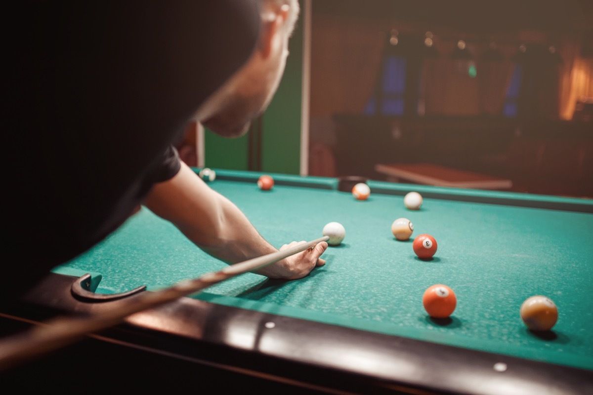 Man shooting pool billiard