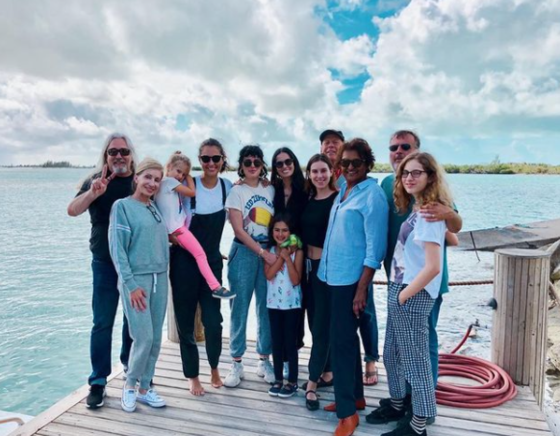 Emma Heming Willis, Bruce Willis, Demi Moore, and others posing for a photo on a dock