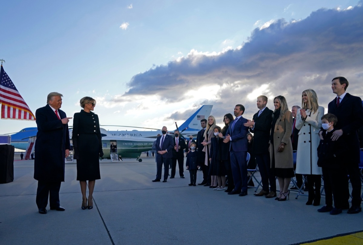 donald and melania trump greet members of the trump family at Joint Base Andrews