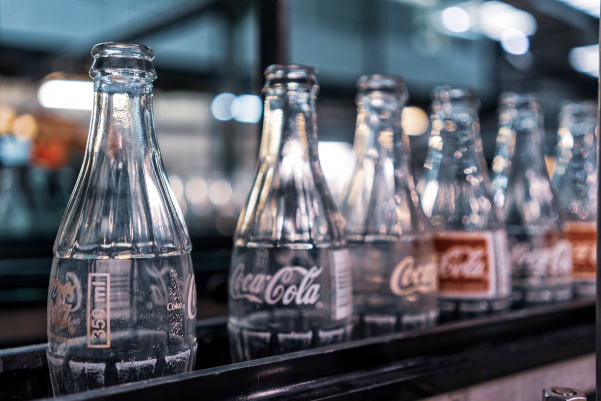 coca cola factory, ready-to-fill bottles on the line