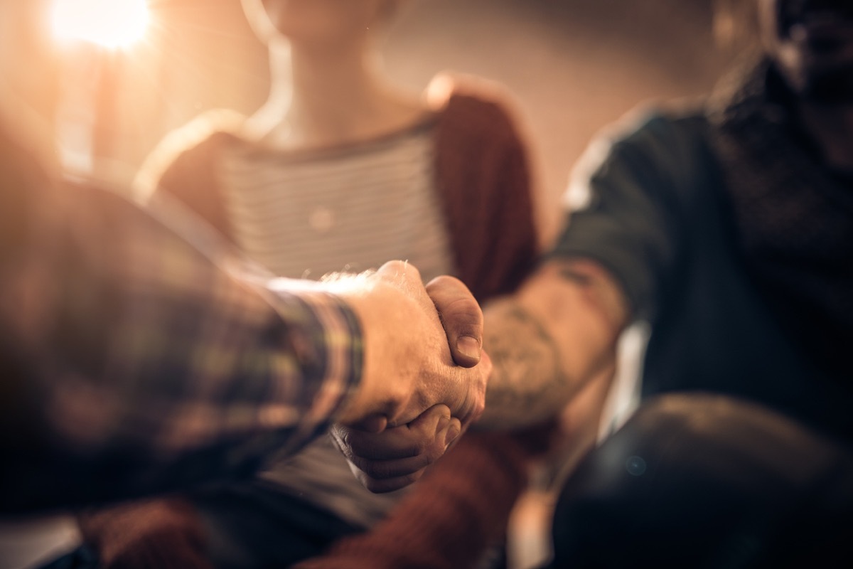 Close up of unrecognizable men shaking hands.