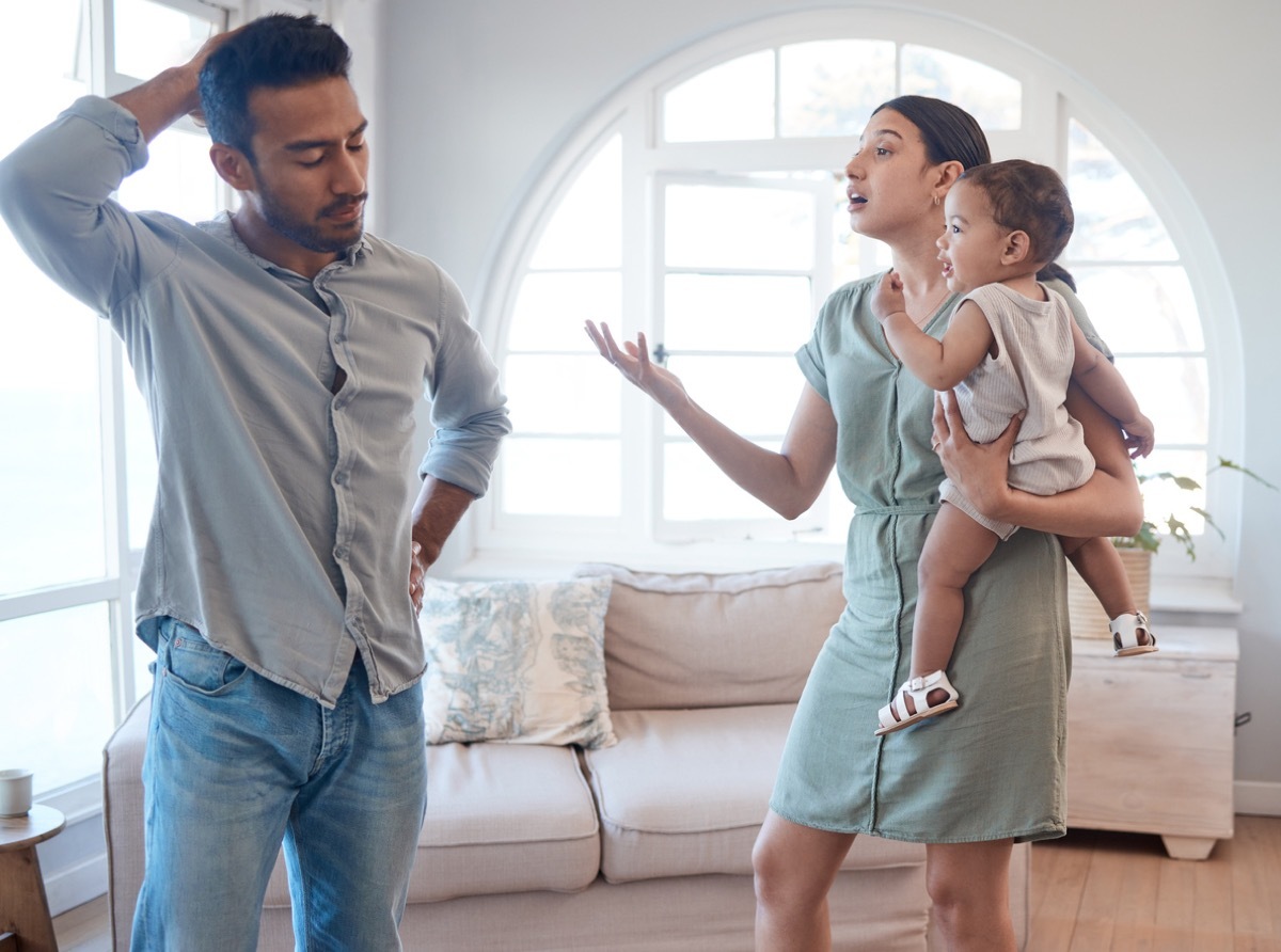 Shot of a young couple looking frustrated and arguing in the lounge at home