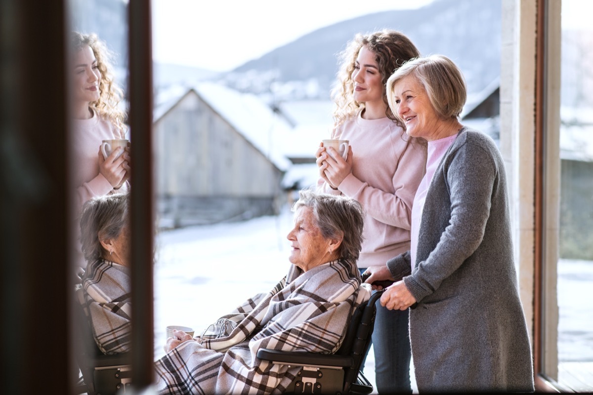 family out in the snow together with mom and grandmother