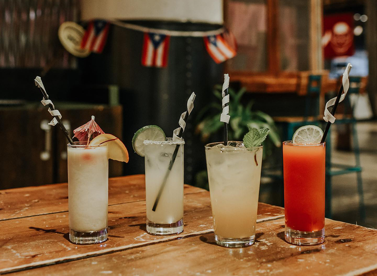 four cocktails on bar