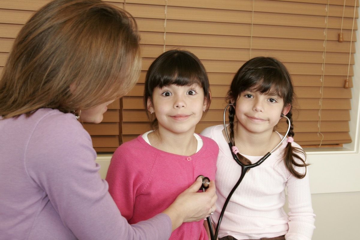 Twin girls being examined by an actual Pediatric doctor.