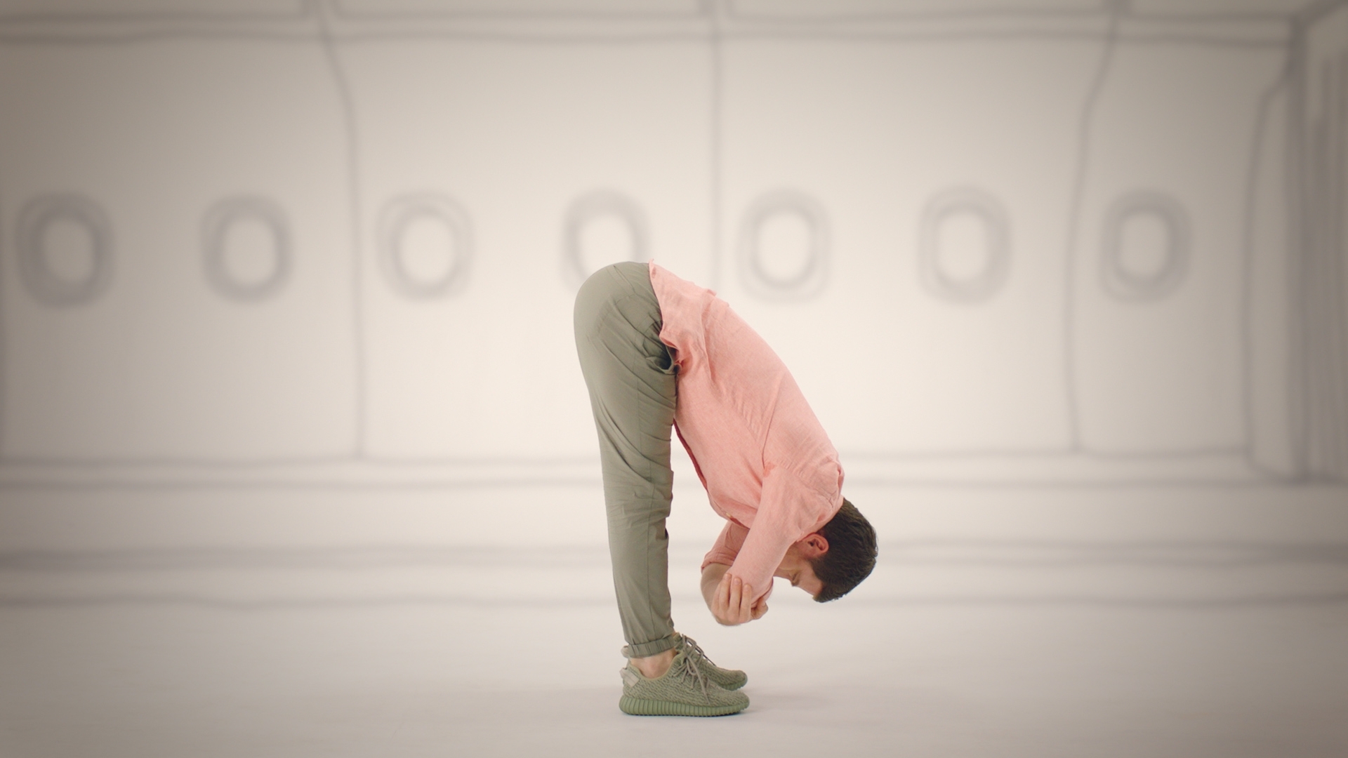 pure yoga instructor does forward fold on cathay pacific yoga video