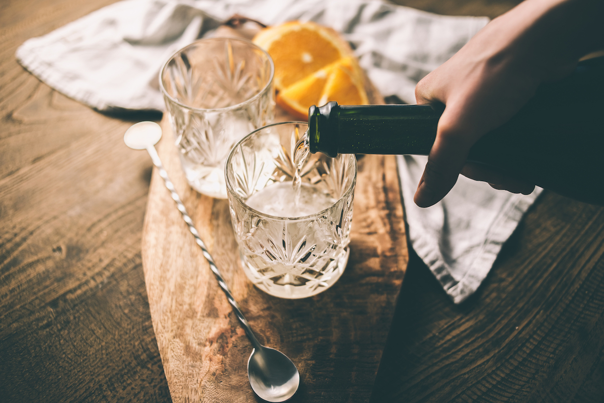 Pouring a drink into cocktail glass