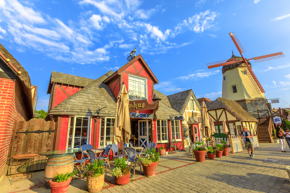 A view down the street of Solvang, California, which looks like a Dutch village with a windmill.