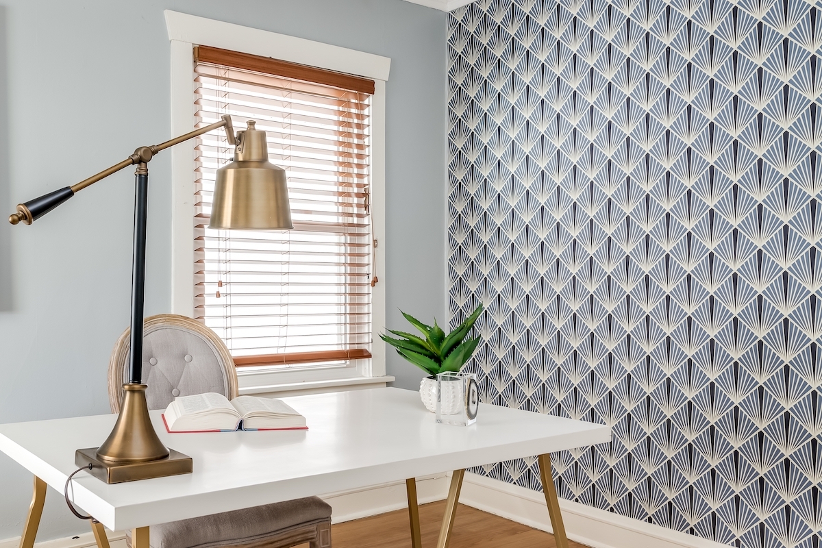 Home Office with Gold Desk Lamp and Bold Geometric Wallpaper