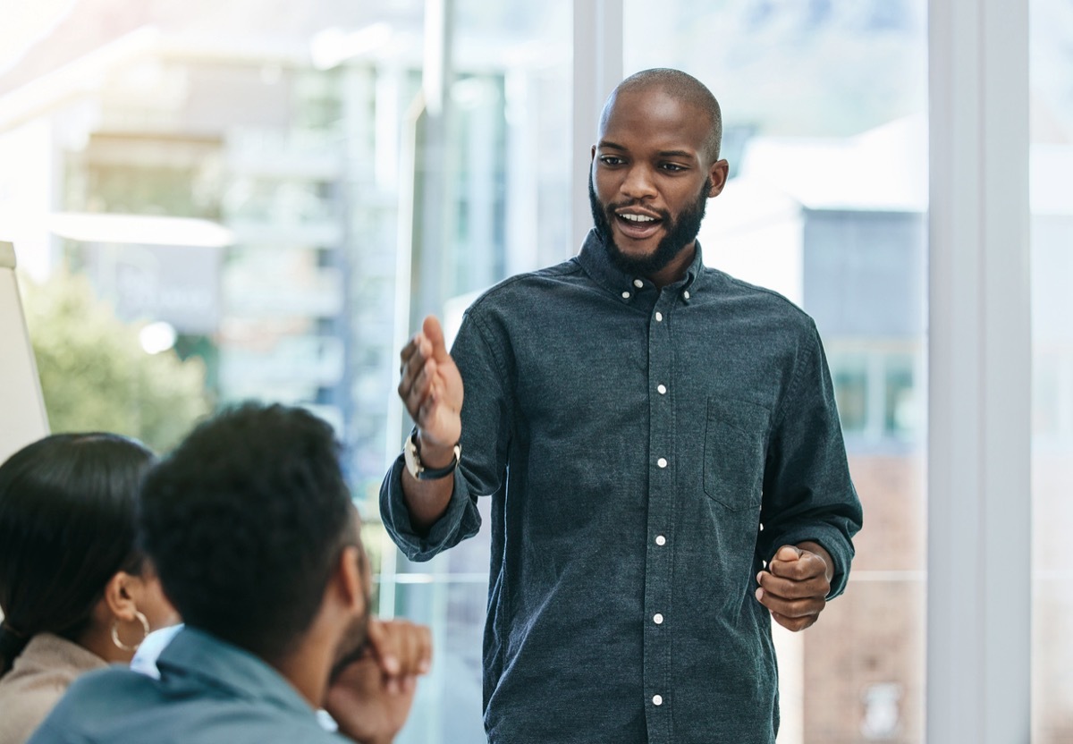 man practicing his speech with small group