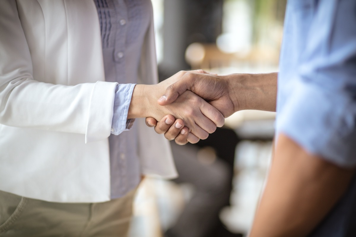 people shaking hands at office