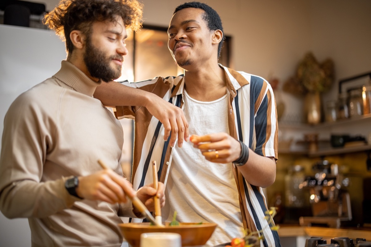 two men joking around in the kitchen