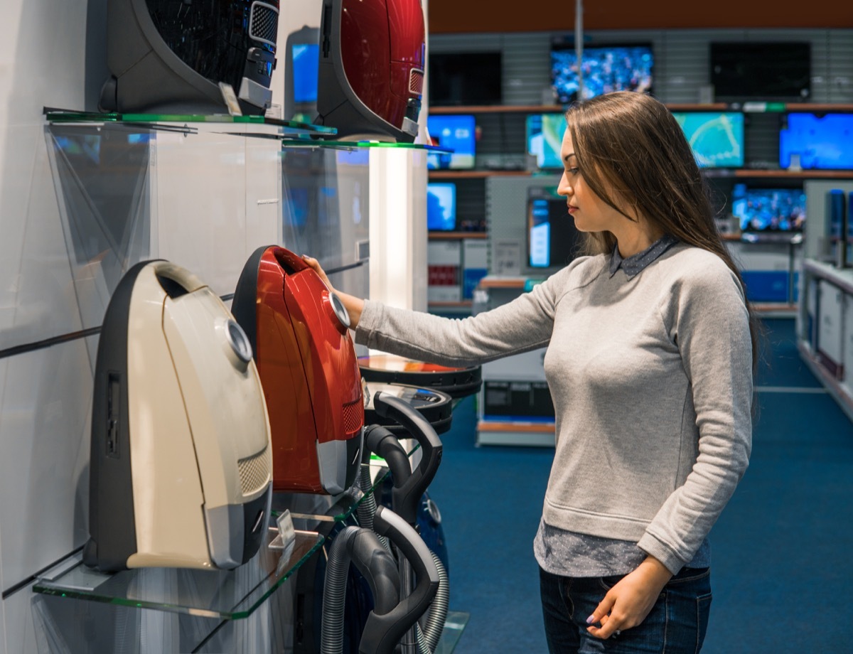 young white woman buying vacuum