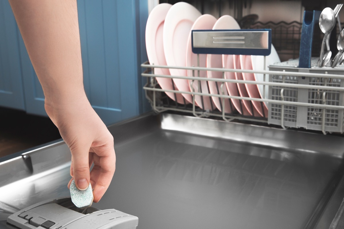 Woman using a dishwasher tablet