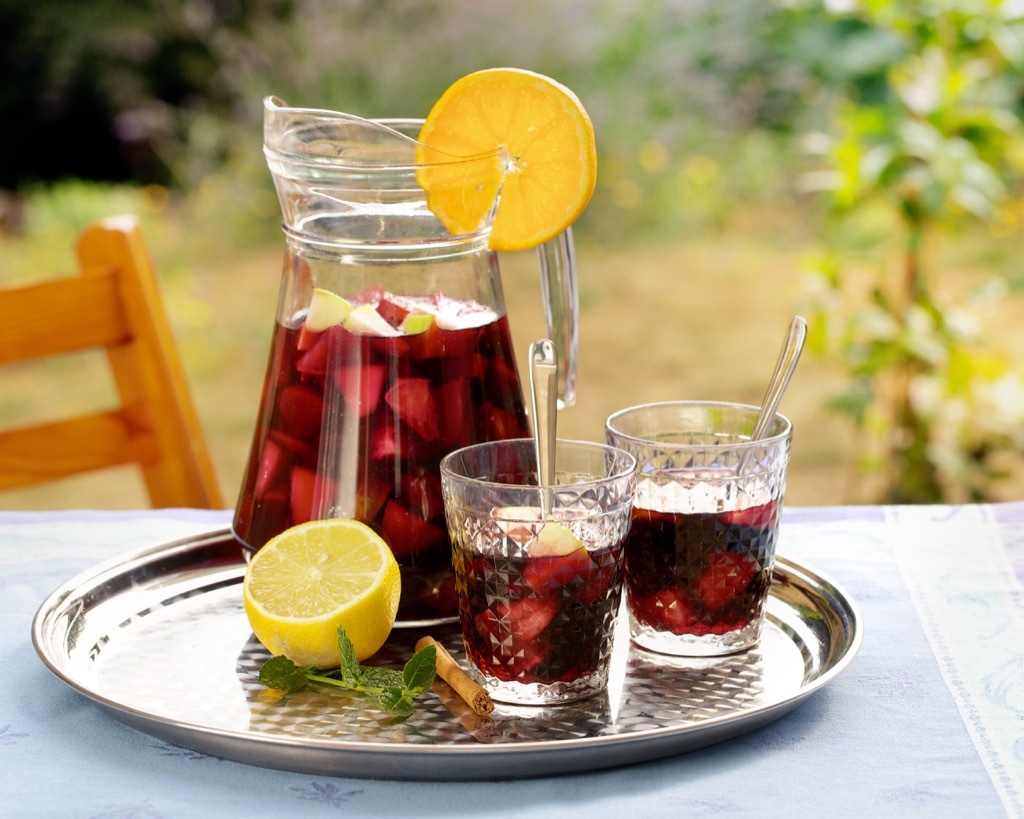 Refreshing summer drink in a pitcher and glasses, sangria