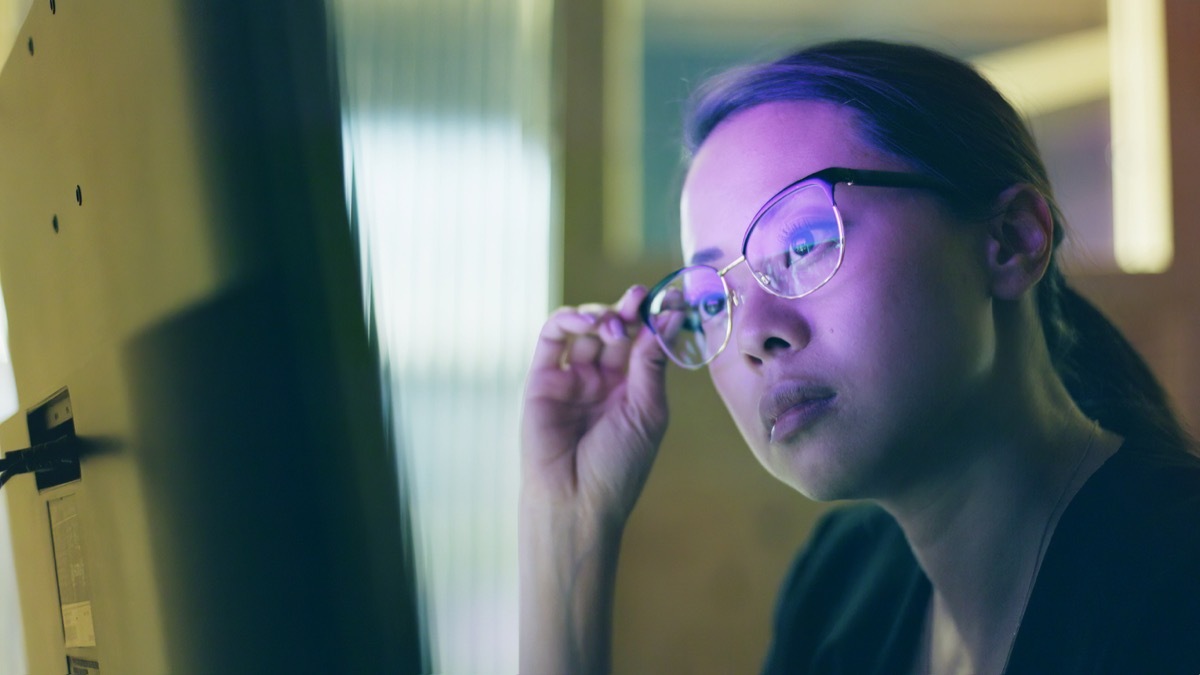 Woman wearing glasses looking at computer screen