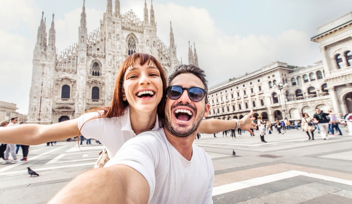 man and woman taking a selfie Duomo cathedral in Milan