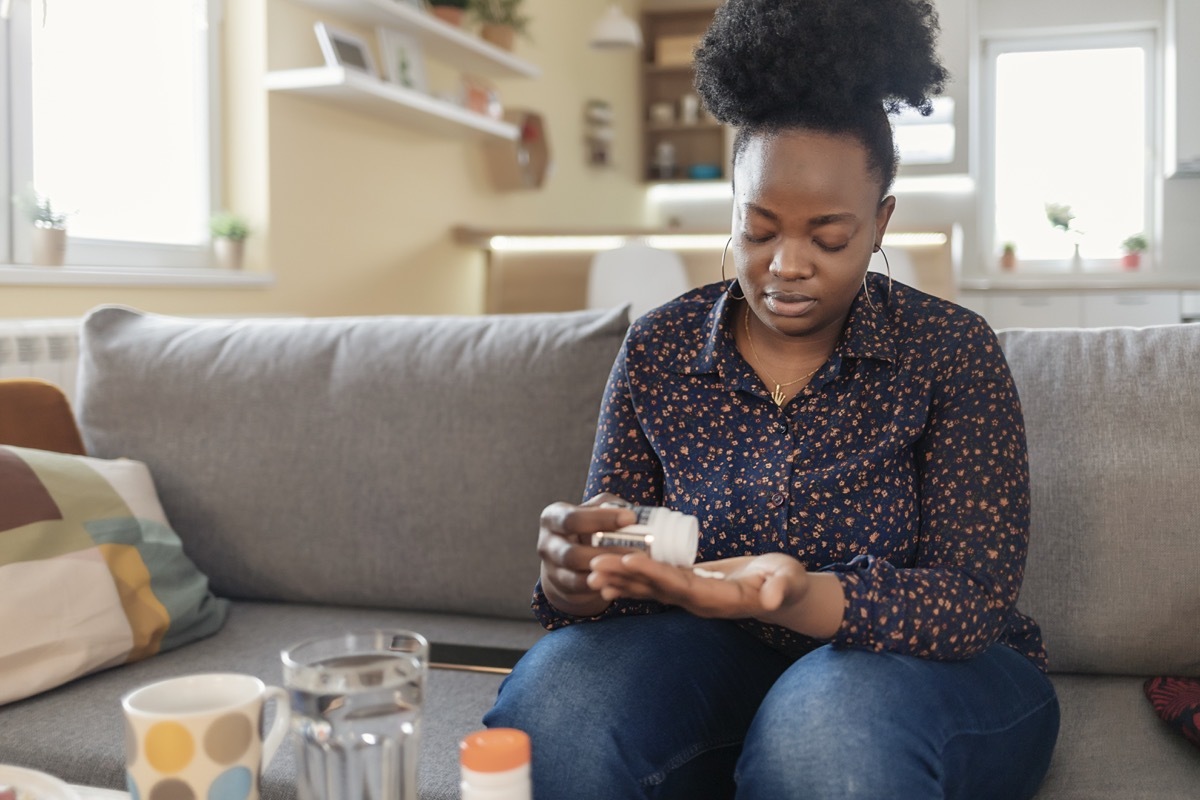 Woman Taking Medication for Her Illness