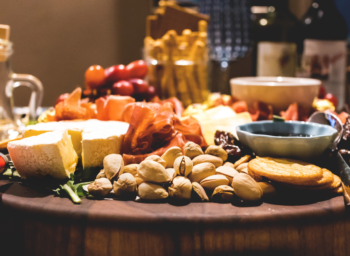 Healthy charcuterie board in shell pistachios cheese