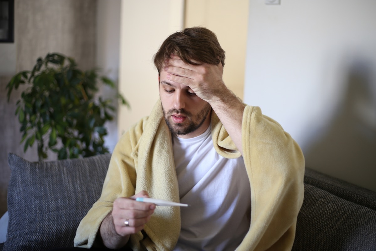 Ill man covered with blanket.