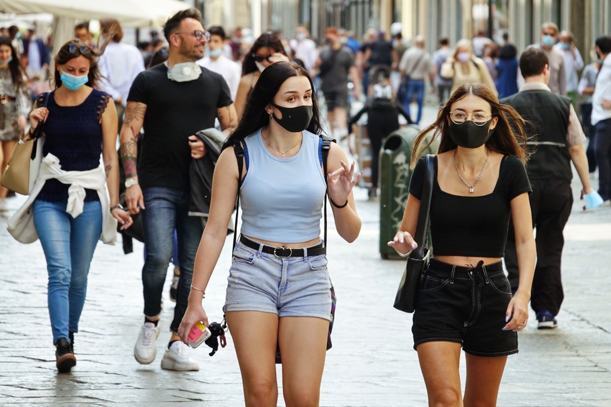 Crowd of people wearing masks outside