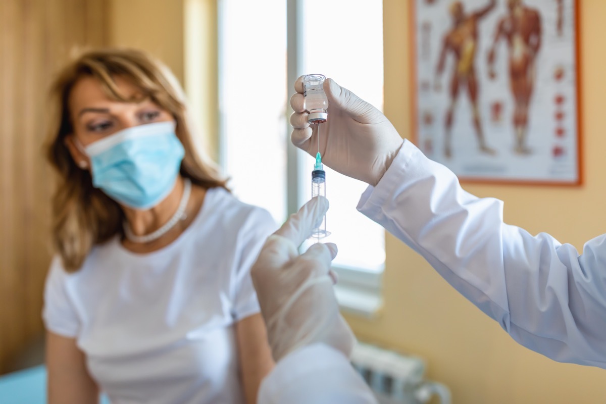 Doctor giving a senior woman a vaccination. Virus protection.