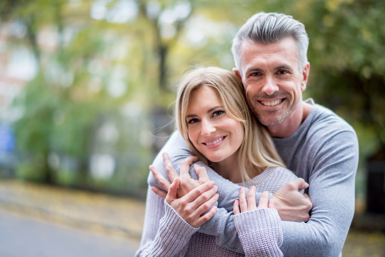 A couple hugging outdoors