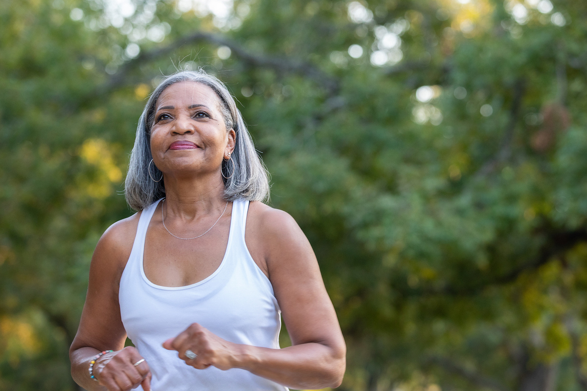 Senior woman walking in public park