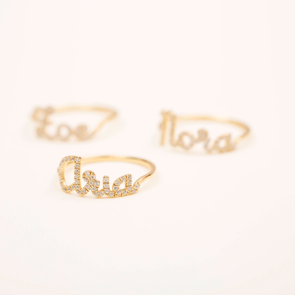 set of three gold name rings with CZ stones