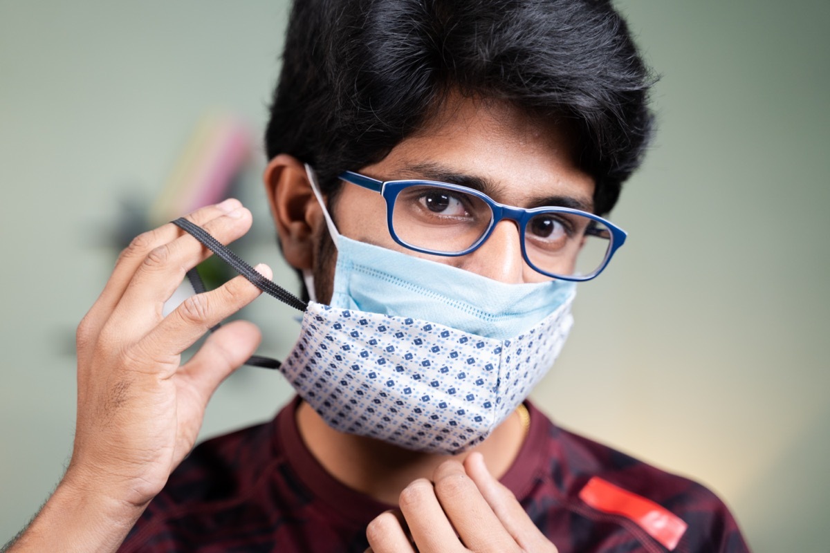 Young man wearing two face masks.