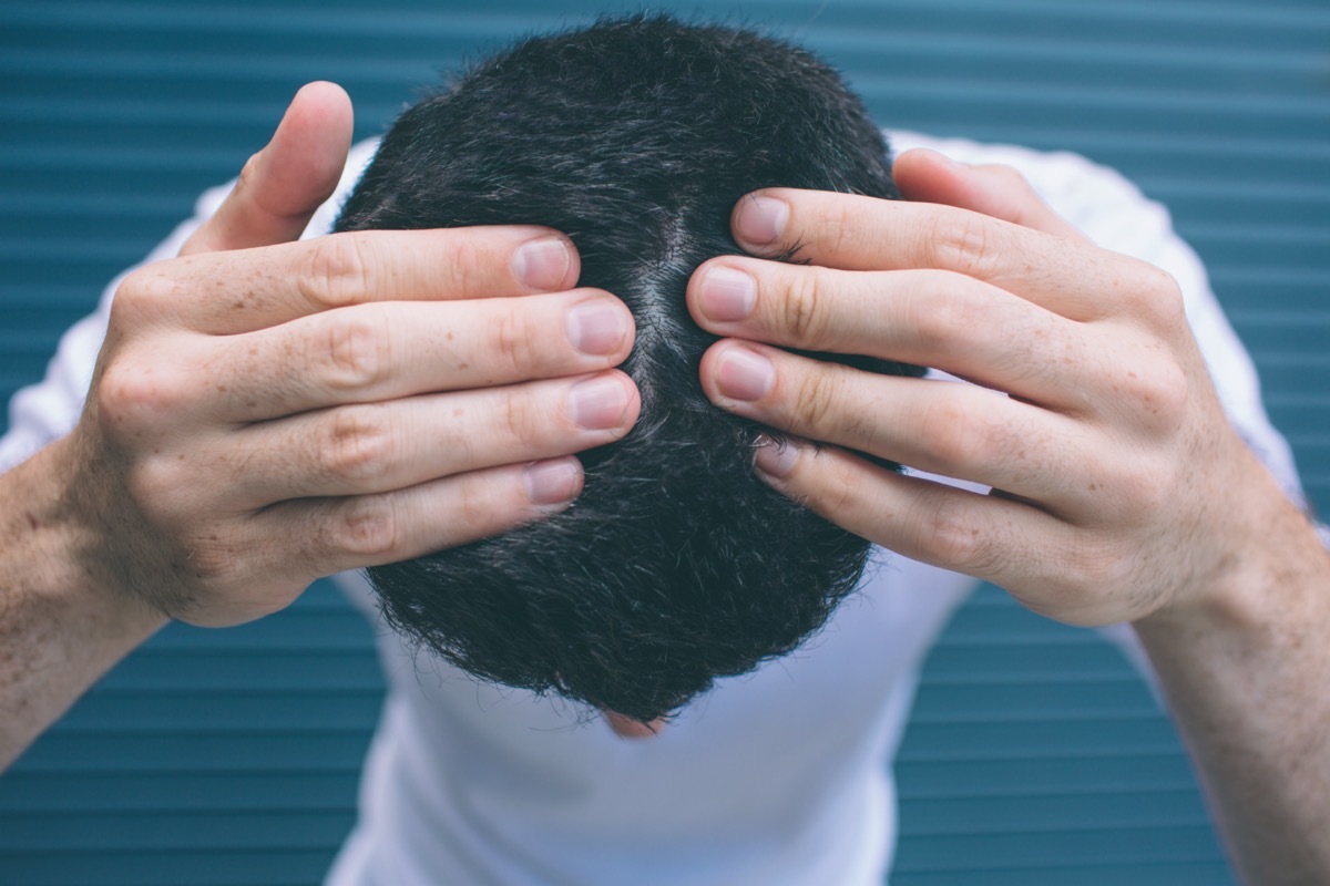 A picture of brunette showing his hair on head