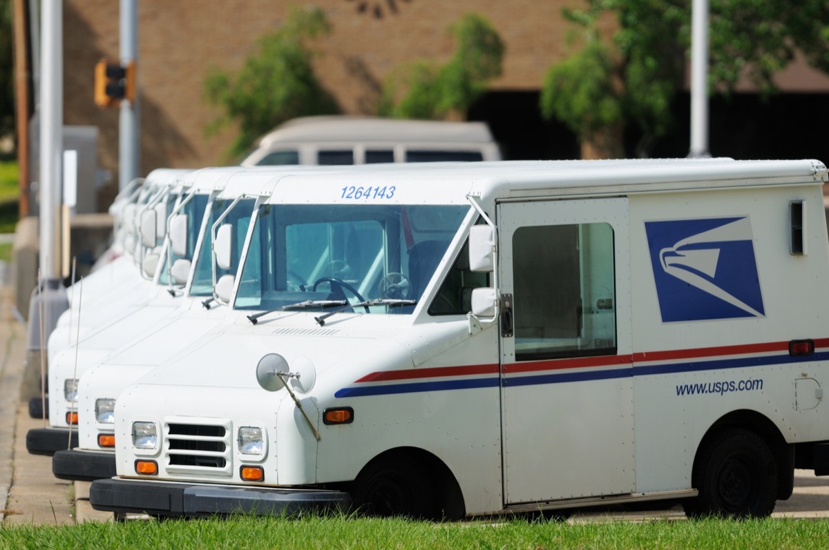 Line of United States Postal Service USPS delivery vehicles or vans in a parking lot. Corner of 9th street and 22nd avenue in downtown Meridian, MS.