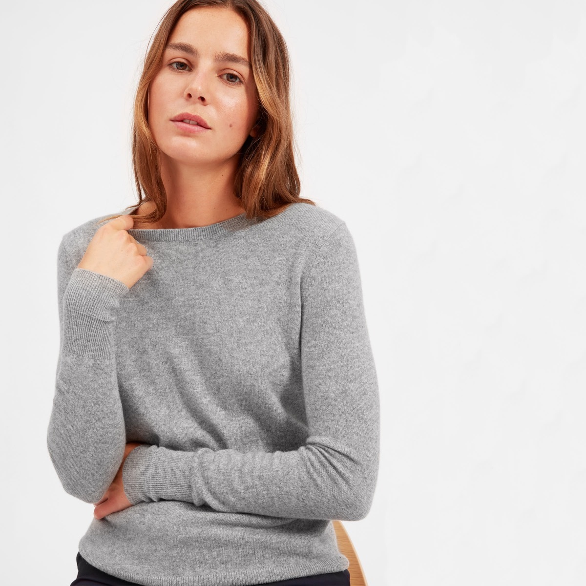 white woman in gray sweater