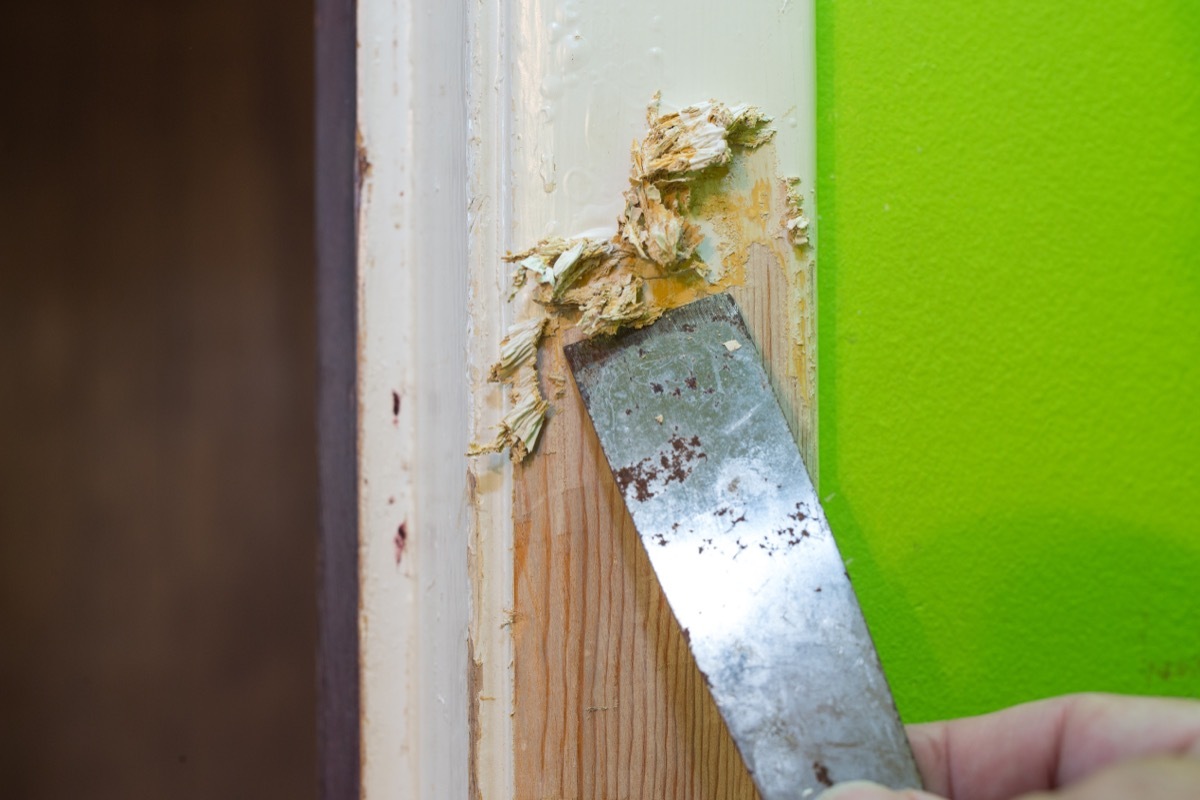 scraping paint from doorway