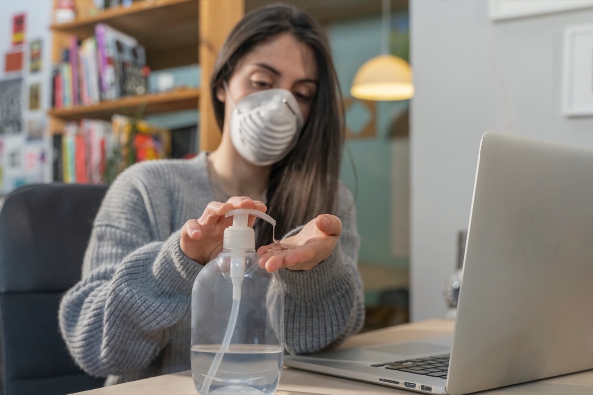 Business woman working from home wearing protective mask