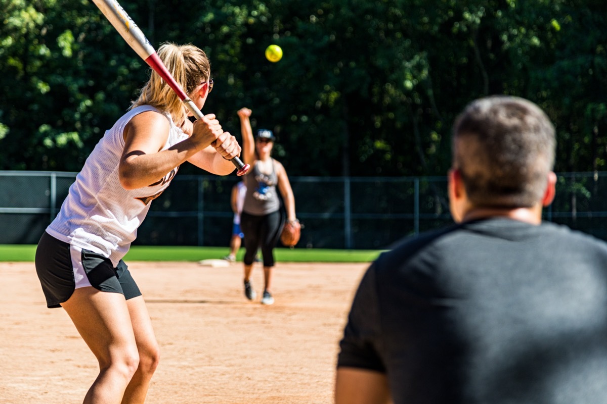 Summer afternoon co-ed softball game at the park