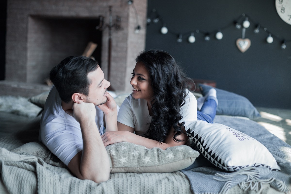 indian couple talking in bed