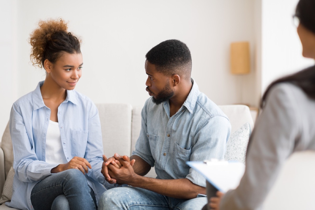 black couple holding hands at couples therapy