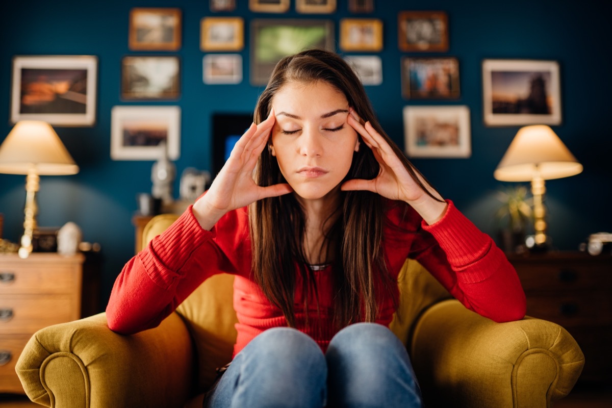 Stressed Woman with Hands on Temples