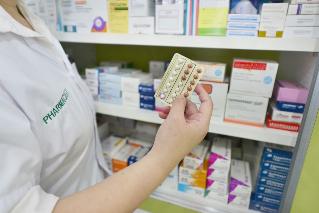 hand holding Birth control pills at pharmacy