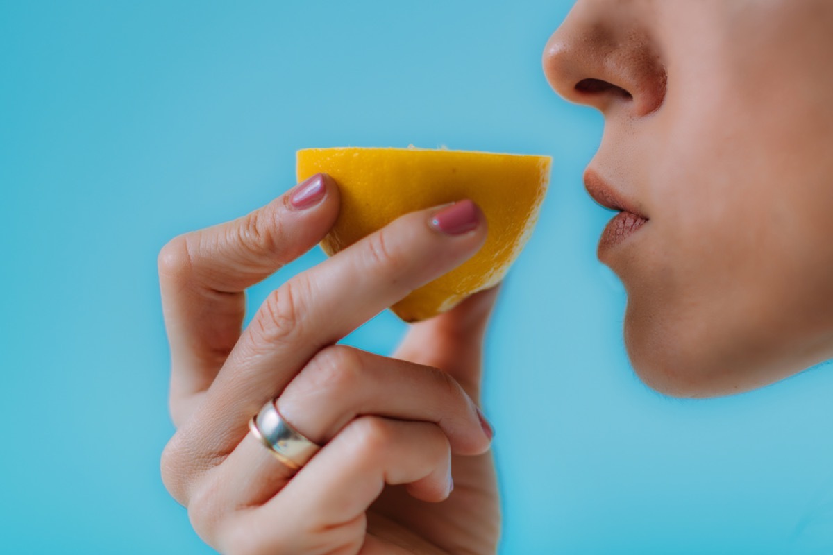 Woman Trying to Sense Smell of a Lemon