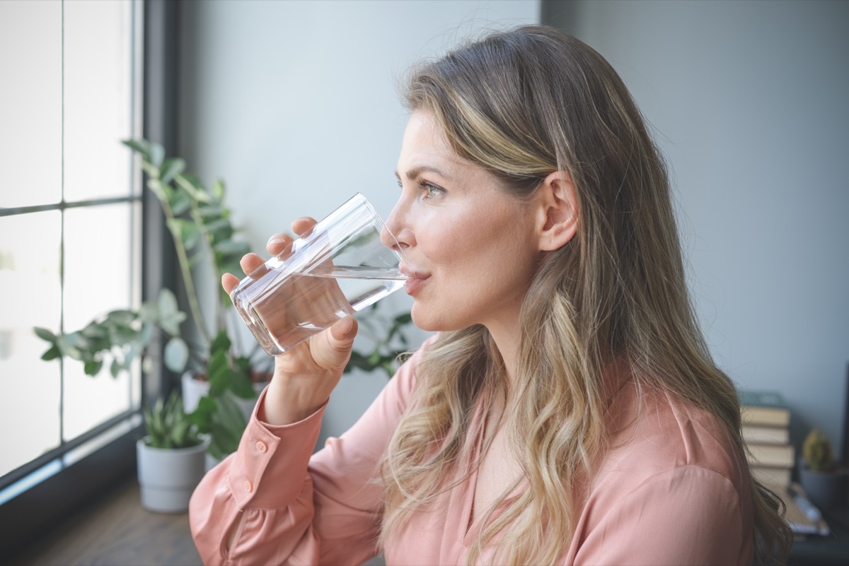 Woman drinking water.