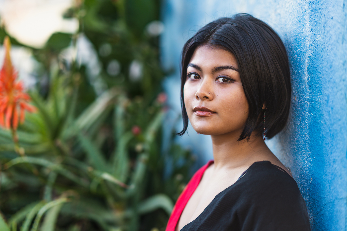 A portrait of a beautiful young mixed-race woman in the city.