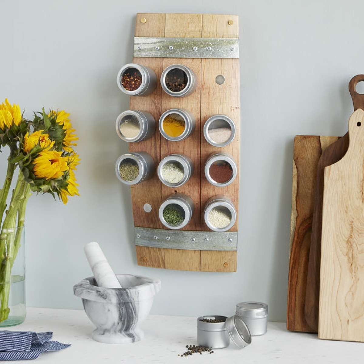 magnetic wooden spice rack next to yellow flowers, kitchen decorations