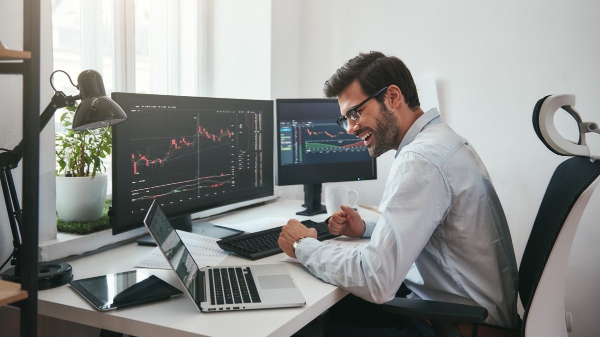 young white man with multiple computer screens