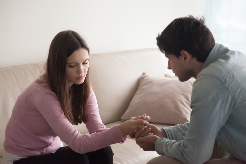 sad woman with guy comforting her