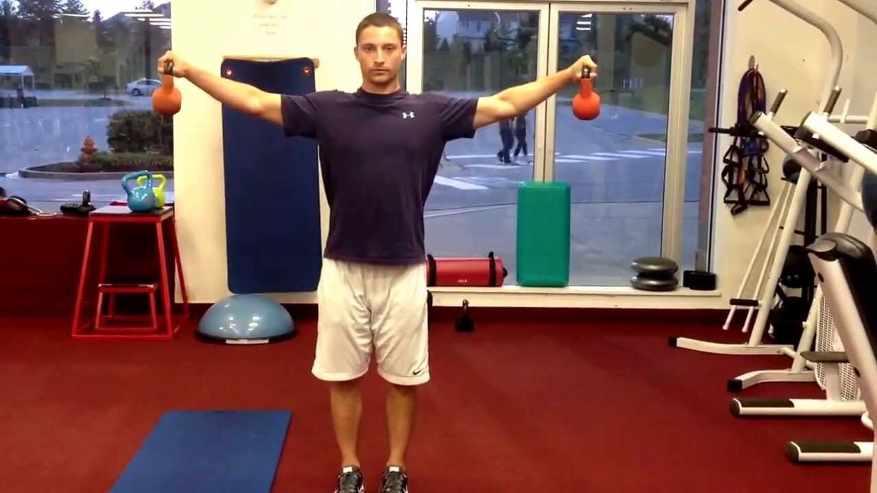 man performs dumbbell iso-holds