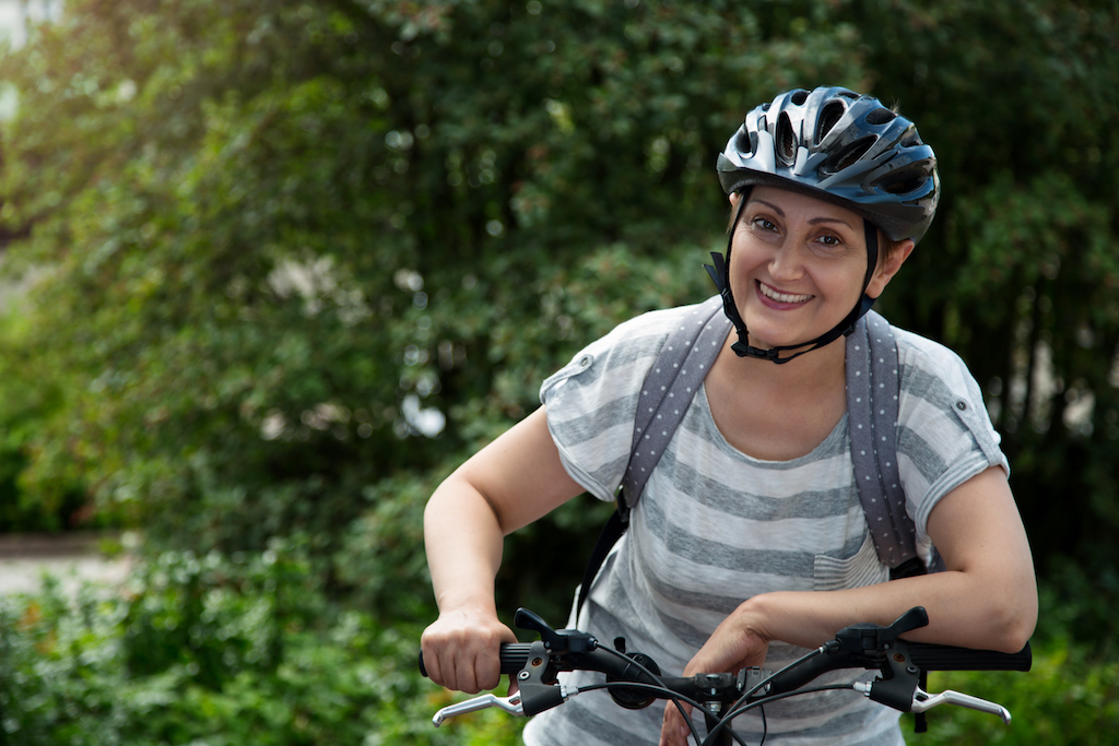 older woman biking, bicycling, exercising