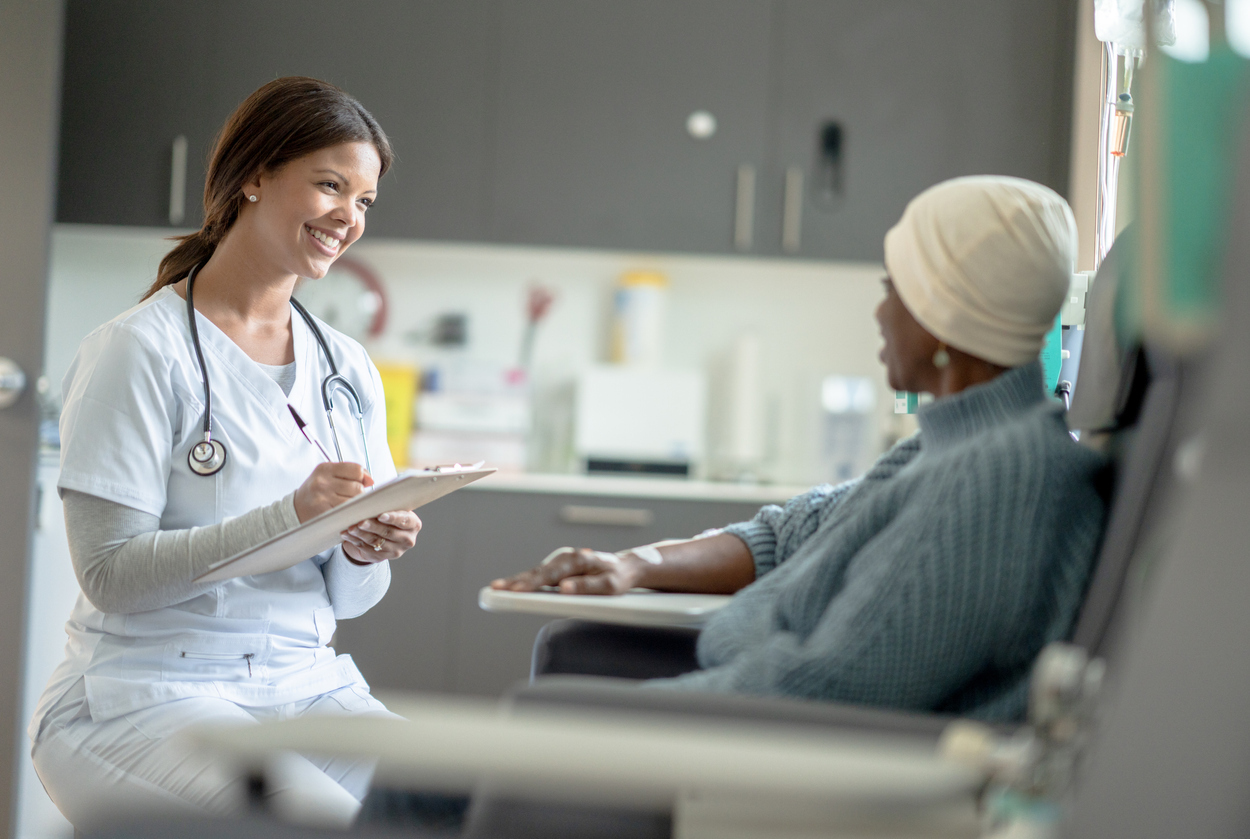 Doctor sitting with a cancer patient.