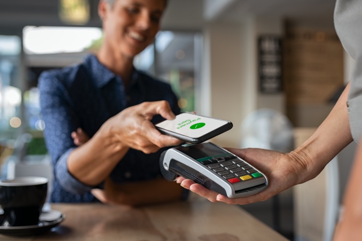 Woman paying with app on her phone